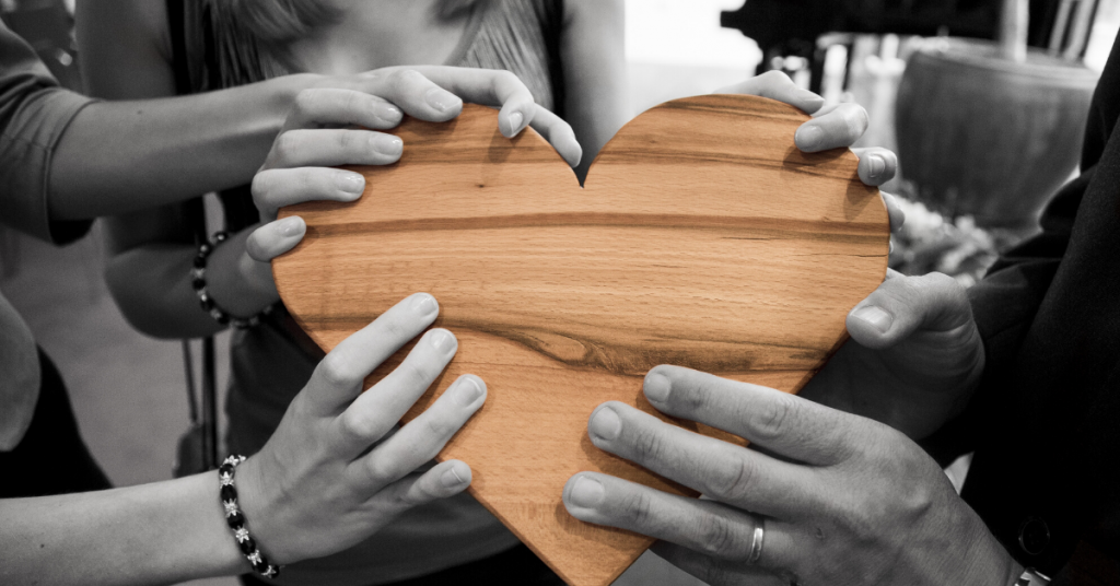 Hands holding wooden heart