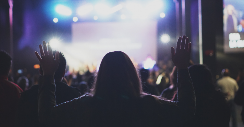 Woman raising hands to worship in church