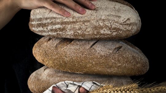 person holding baked bread representing how God will provide