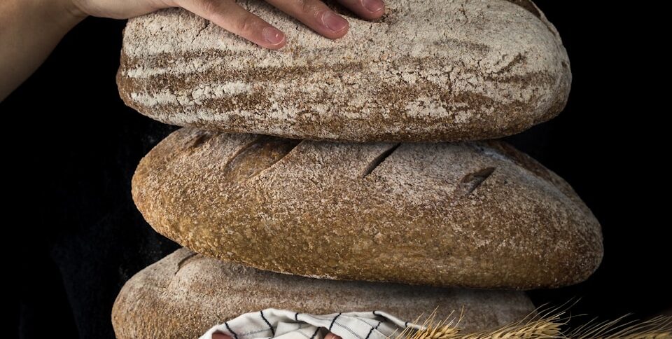 person holding baked bread representing how God will provide